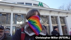 A transgender rights activist stands in a park for a rally on November 18. Organizers were forced to abandon the event after far-right counterdemonstrators assaulted several protesters and attacked a Canadian journalist.