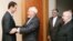 Syrian President Bashar al-Assad (left) welcomes Iranian Foreign Minister Mohammad Javad Zarif before a meeting in Damascus on January 15.