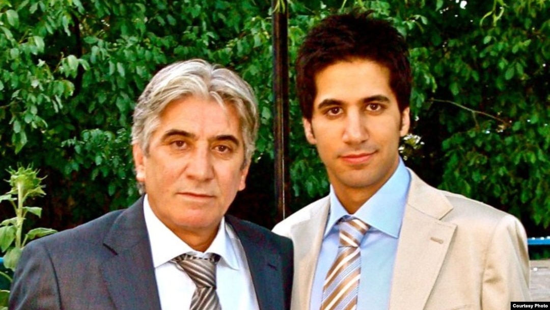 Iranian asylum seeker Yashar Khameneh (right) with his father, who he says has been imprisoned over his son's Internet activities