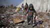 An Afghan child looks for plastic and other items, which can be used as a replacement for firewood, at a garbage dump in Kabul. (file photo)