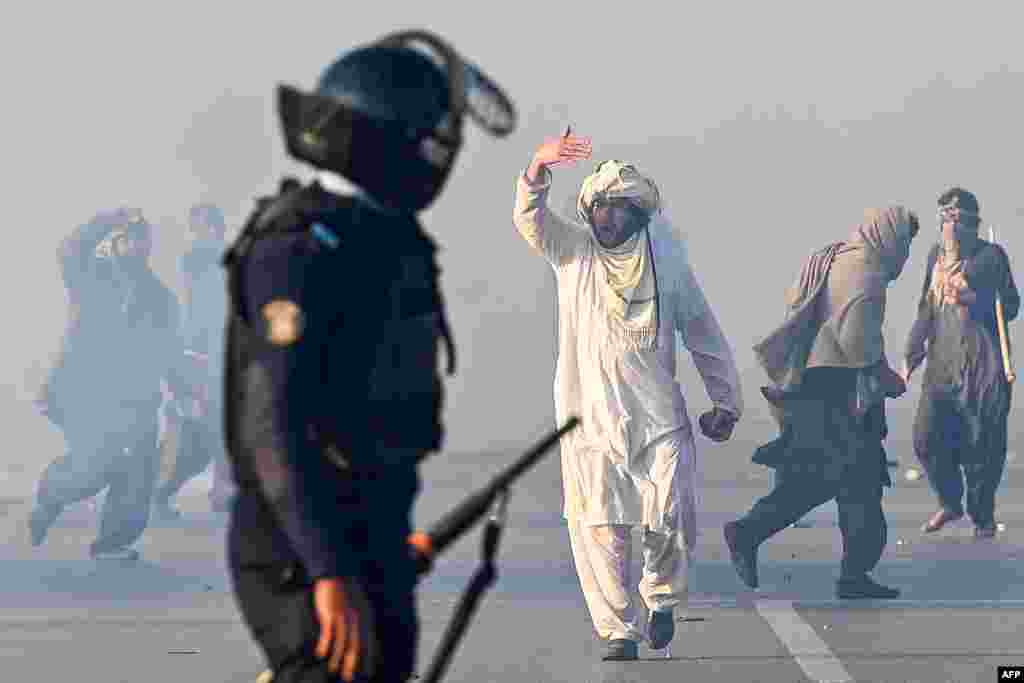 A supporter of the Pakistan Tehrik-e Insaf party gesticulates after tear gas was fired by police to disperse a crowd protesting in Islamabad to demand the release of jailed former Prime Minister Imran Khan.&nbsp;