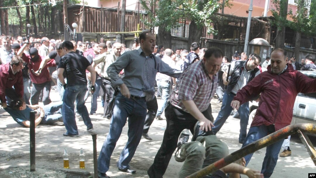 Georgian riot police clash with opposition protesters in Tbilisi in mid-June.
