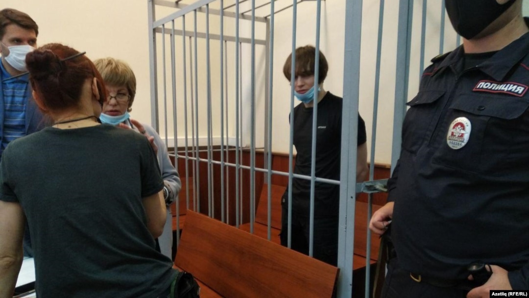 Azat Miftakhov in the defendant's cage at a court hearing in Moscow earlier this week. 