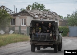 Soldați ucraineni într-un vehicul militar în apropiere de granița dintre Ucraina și Rusia, în orașul Vovceansk, regiunea Harkov, la 5 iunie.