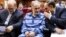 Mohammad Ali Najafi (center) in handcuffs in a Tehran court