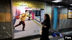 Homeless child sleeping in metro passageway in Tehran, Iran, 2018.