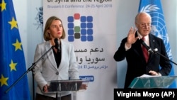 EU foreign policy chief Federica Mogherini (left) and UN Special Envoy for Syria Staffan de Mistura talk to journalists in Brussels on April 24. 