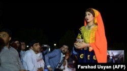 FILE: An Afghan model displays her outfit at a fashion show in the northern Afghan city of Mazar-e Sharif in April 2018.