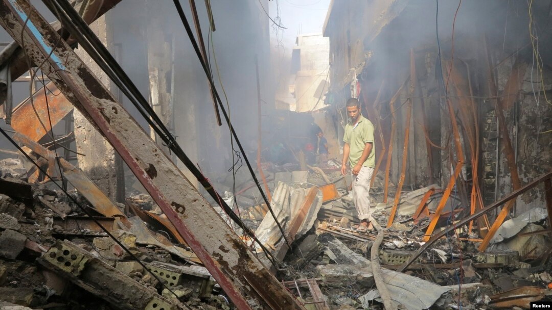 Residents gather at a market destroyed after an attack by Iraqi security force helicopters in Ramadi in June during fighting with Islamic State militants.