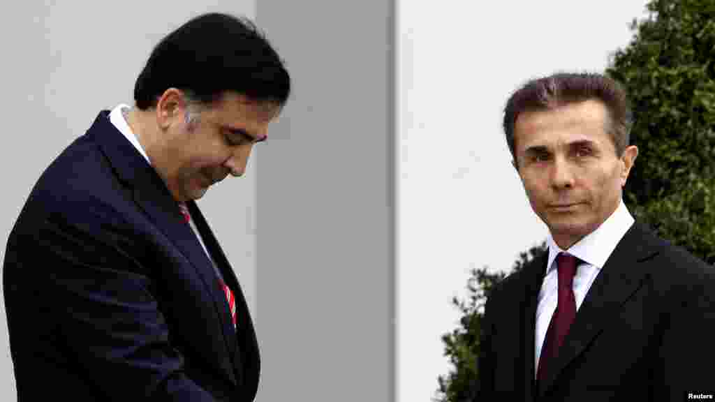 President Mikheil Saakashvili (left) greets Bidzina Ivanishvili, prime minister nominee and Georgian Dream coalition leader, before their meeting at the Presidential Palace in Tbilisi on October 9, 2012.