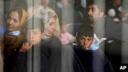 Evacuees from Afghanistan wait to fly to the United States or another safe location in a makeshift departure gate inside a hanger at the United States Air Base in Ramstein, Germany. (file photo)