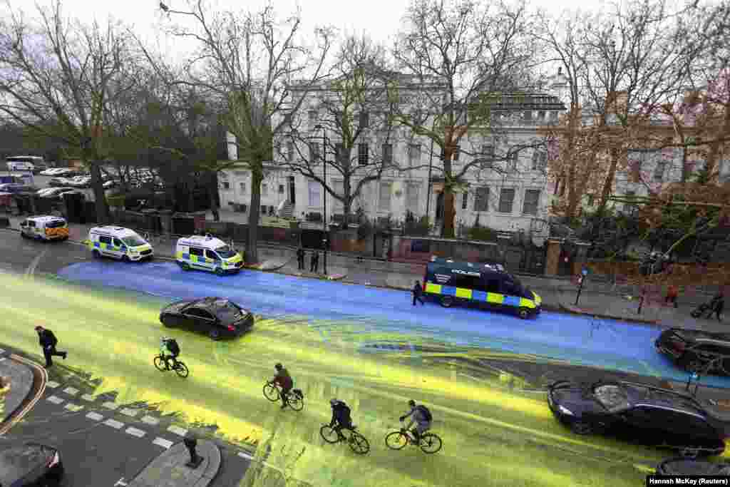 The street in front of the Russian Embassy in London stained in the colors of the Ukrainian flag after vandals protesting the invasion covered it with paint in February 2023