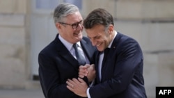 Președintele Franței, Emmanuel Macron (dreapta), îl întâmpină pe prim-ministrul britanic, Keir Starmer, la sosirea acestuia pentru a coprezida o reuniune a aliaților privind Strâmtoarea Ormuz, la Paris.