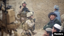 U.S. Marines greet children during a patrol in Helmand (file photo, 2010).