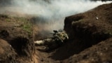 A soldier lies in a trench near Vuhledar, in Ukraine's Donetsk region.