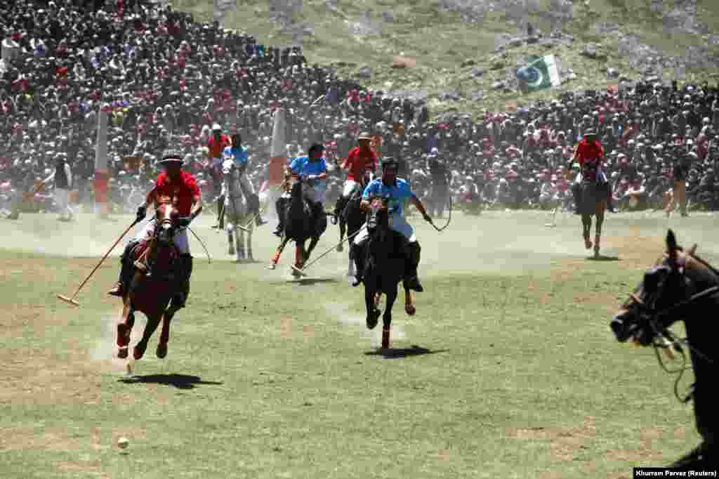 Players fight for the ball during the annual Shandur Polo Festival at Shandur Pass at an estimated altitude of 3,700 meters in Chitral, Pakistan. (Reuters/Khurram Parvez)