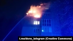 The top floors of a five-story building in Ukraine's Chernihiv region burn after a Russian strike.