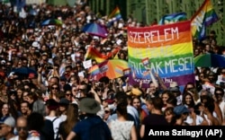 People march across the Szabadsag, or Freedom Bridge, over the River Danube in downtown Budapest during a gay pride parade in Budapest in July 2021.
