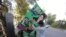 Supporters of opposition political party Pakistan Muslim League Nawaz (PMLN) install posters at the party's senior leaders residence in Lahore as major political parties gear up for an anti-government rally on October 15 