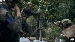 Ukrainian soldiers launch a shell toward Russian forces in recently liberated Kupyansk in the Kharkiv region on September 22.