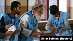 Afghan election commission workers count ballot papers from the September 28 presidential election in Kabul.