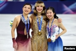 Олимпиада чемпионы америкалық Алиса Лю (ортада), күміс жүлдегер Каори Сакамото (сол жақта) және қола жүлдегер Ами Накаи (оң жақта) тұғырда тұр. Милан, Италия, 19 ақпан, 2026 жыл.