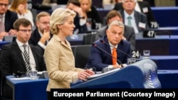 European Commission President Ursula von der Leyen speaks at the European Parliament on October 9 as Hungarian Prime Minister Viktor Orban (right) looks on.