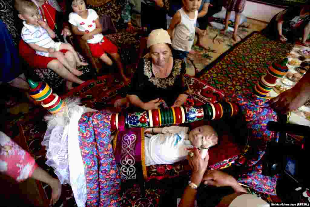 Darkhan is laid in the cradle, where important guests place sweets.