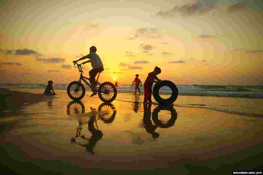 Palestinian children play on the beach in Gaza City on September 21. (AFP/Mohammed Abed)