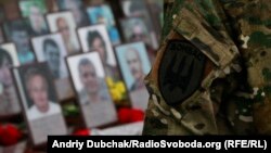 People lay flowers at a memorial in central Kyiv on November 21.