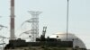 File - An anti aircraft gun is seen in front of the reactor building of the Bushehr nuclear power plant, February 26, 2018