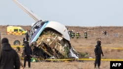 Emergency specialists work at the crash site of an Azerbaijan Airlines passenger jet near the western Kazakh city of Aqtau on December 25. 