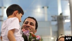 Iranian nuclear scientist Shahram Amiri is welcomed by family members upon his arrival at Imam Khomeini Airport in Tehran on July 15.