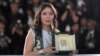 FRANCE -- Kazakh actress Samal Yeslyamova poses with her trophy during a photocall after she won the Best Actress Prize for her part in "Ayka (My Little One)" at the 71st edition of the Cannes Film Festival in Cannes, May 19, 2018