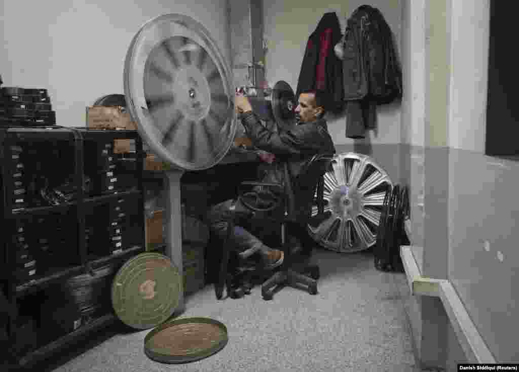 An employee winds a roll of film in the projection room at the Ariana Cinema.