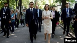 French President Emmanuel Macron walks with Moldovan President Maia Sandu in Chisinau on June 15.