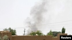 Smoke rises from a residential as the Taliban battled the Afghan security forces in Ghazni on August 10.