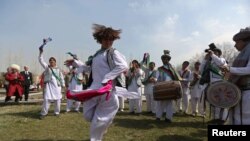 Afghan artists perform the traditional "attan" dance during the Norouz celebrations in Kabul March 27, 2014.