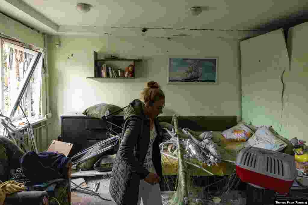 Vita Tkachenko, who was injured by flying debris while asleep, inspects the damage to her apartment after a Russian drone strike in Kyiv on October 29.