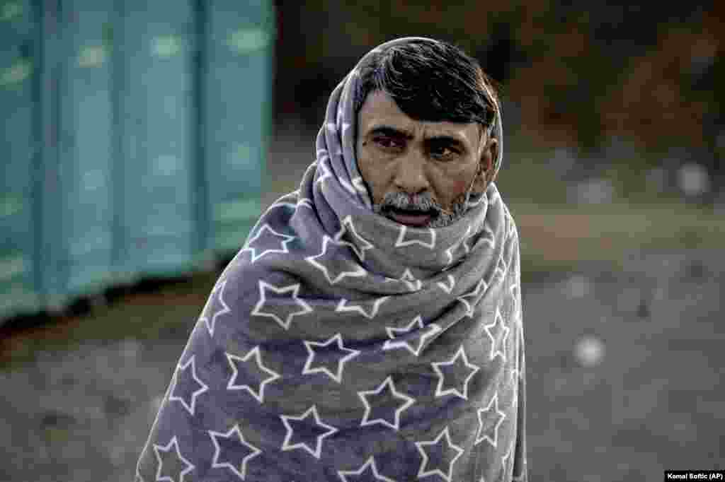 A migrant walks covered in a blanket during a visit by European Commissioner for Home Affairs Ylva Johansson at the Lipa camp outside Bihac, Bosnia. Migrants have suffered from cold and hunger during the winter after they were sent back after crossing into Italy from Slovenia, which then sends them packing to Croatia, which then pushes them back into Bosnia, after their failed attempts to cross into the European Union. (AP/Kemal Softic)