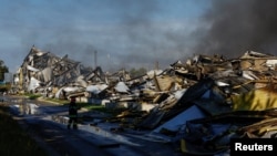 A firefighter works at the site of a warehouse hit by a Russian drone strike in the Kyiv region on September 27. 
