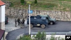 Grupa naoružanih i maskiranih muškaraca ispred manastira Banjska nakon napada na kosovsku policiju, 24. septembar 2023.