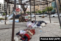 Displaced children sleep on the sidewalk in downtown Beirut.