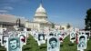 Activists opposing the government of Iran place the images of victims of state-sponsored executions of political prisoners in 1988 in Iran, on the East Front of the US Capitol in Washington, September 12, 2019