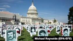 Activists opposing the government of Iran place the images of victims of state-sponsored executions of political prisoners in 1988 in Iran, on the East Front of the US Capitol in Washington, September 12, 2019