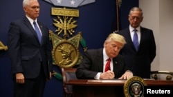 U.S. President Donald Trump signing the first executive order on travel on January 27.