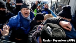 Kazah rendfenntartók vesznek őrizetbe egy tüntetőt Almatiban egy korábbi, tavalyi tüntetésen, 2021. február 28-án