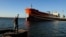  A man fishes near a Cuban-flagged docked at the Matanzas terminal, where a Russian oil tanker was to offload, on February 10.