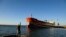  A man fishes near a Cuban-flagged docked at the Matanzas terminal, where a Russian oil tanker is likely to offload.