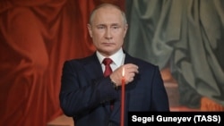 Russian President Vladimir Putin makes the sign of the cross during a Mass earlier this year at Moscow's Cathedral of Christ the Savior.